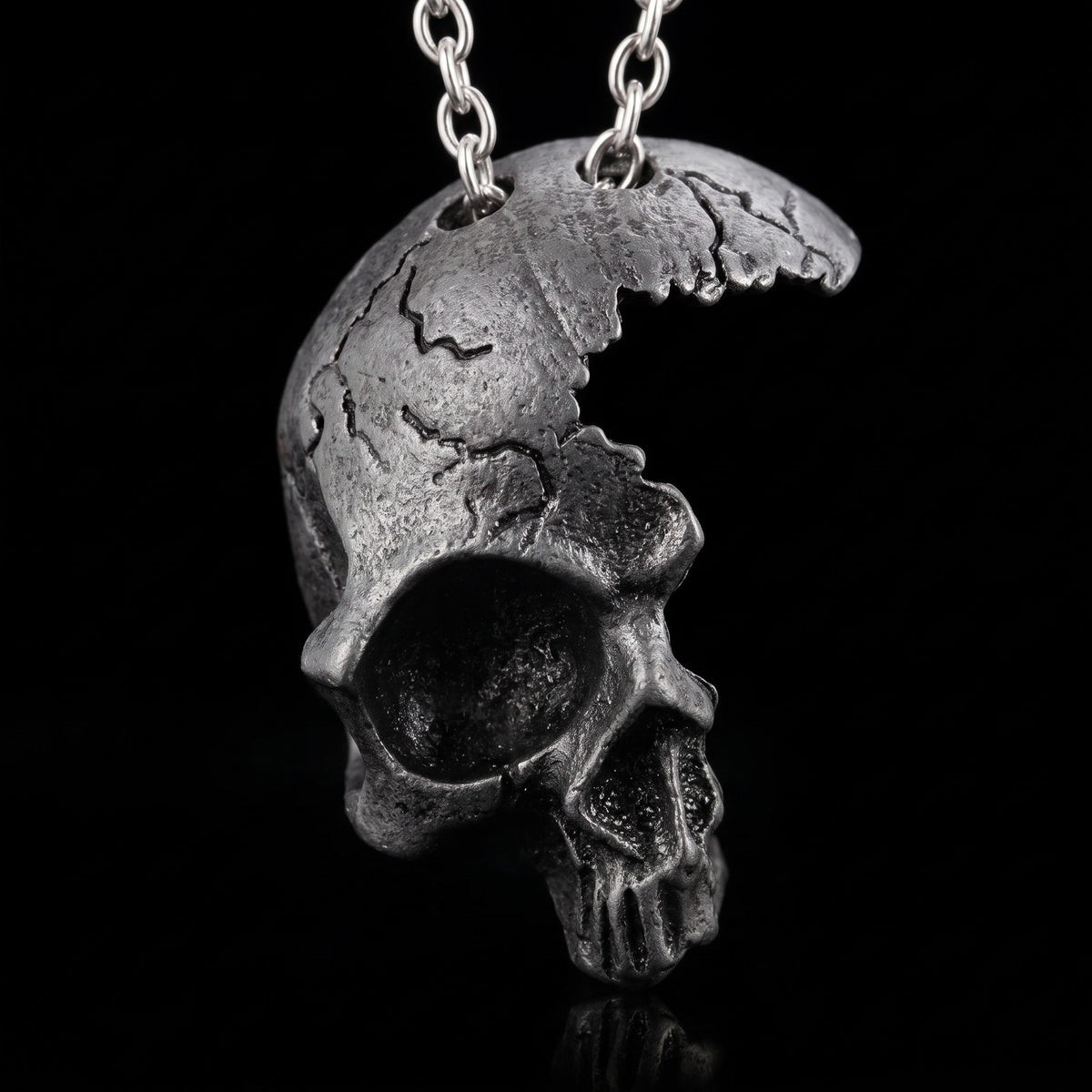 Macro close-up of the Broken Skull pendant in 316L stainless steel, Outlaws Amsterdam