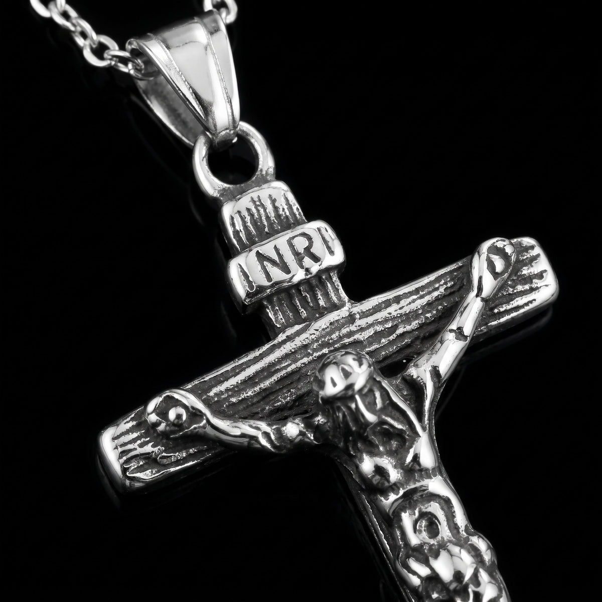 Macro close-up of the Jesus Piece pendant in 316L stainless steel, Outlaws Amsterdam