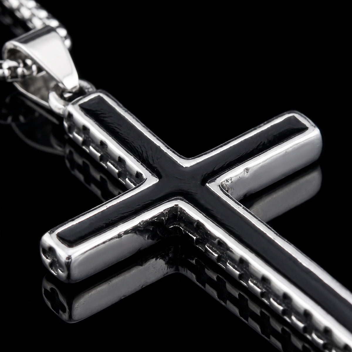 Macro close-up of the Onyx Cross pendant in 316L stainless steel, Outlaws Amsterdam