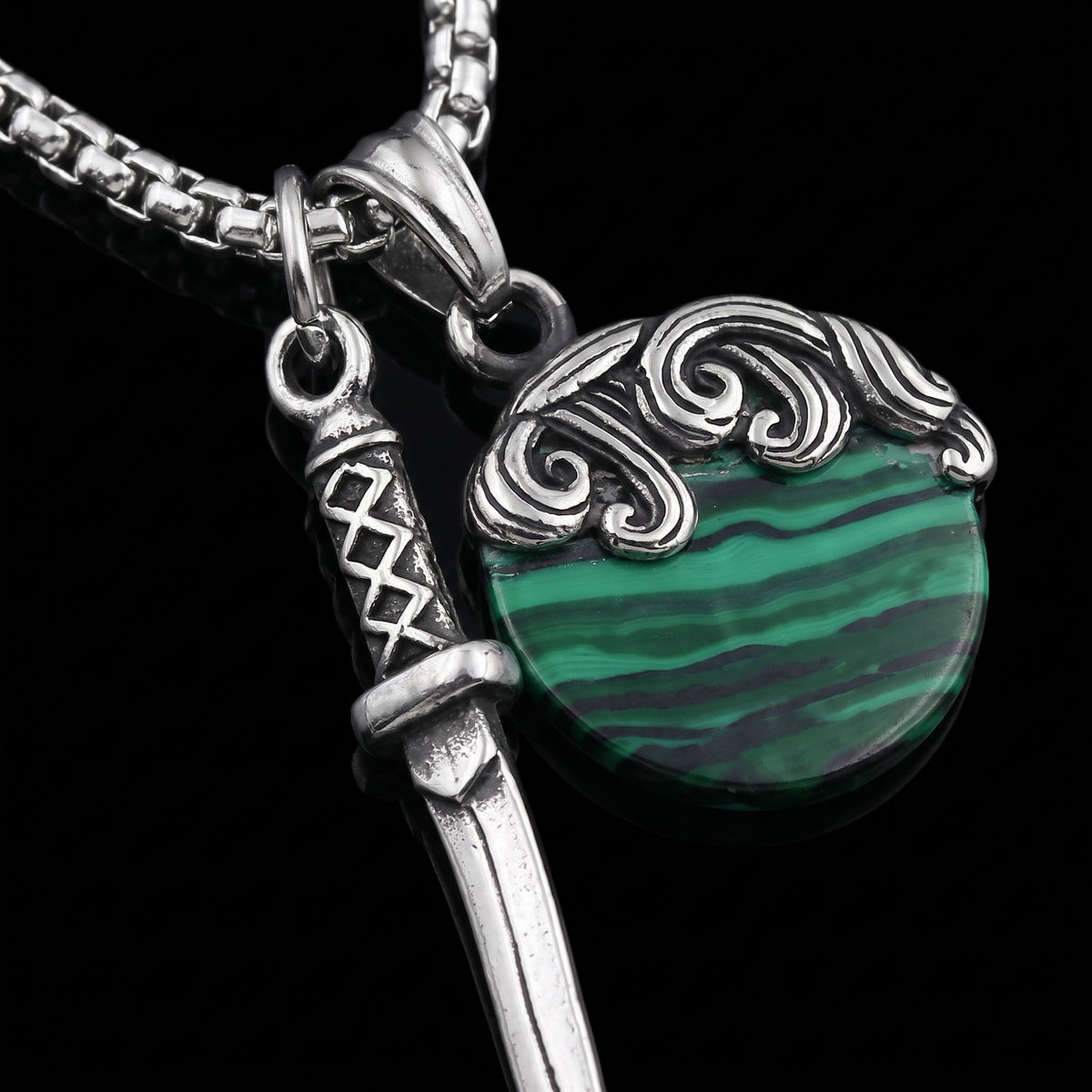 Macro close-up of the Shield & Sword pendant in 316L stainless steel, Outlaws Amsterdam