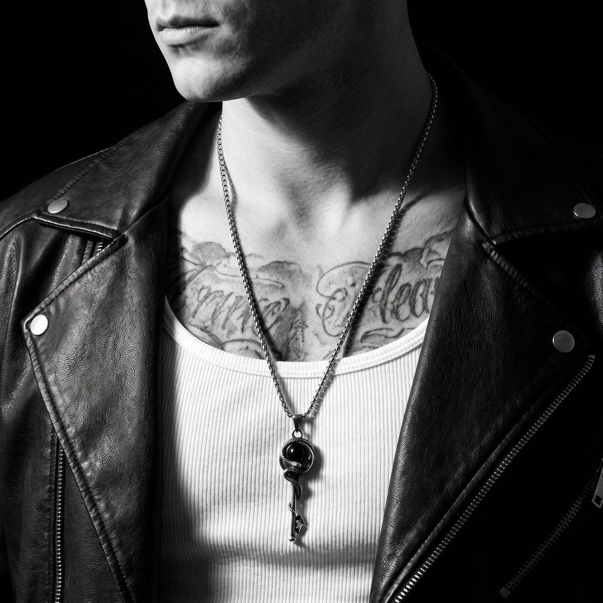 Man wearing the Snake Key pendant on a chain, worn on the chest, 316L stainless steel, Outlaws Amsterdam