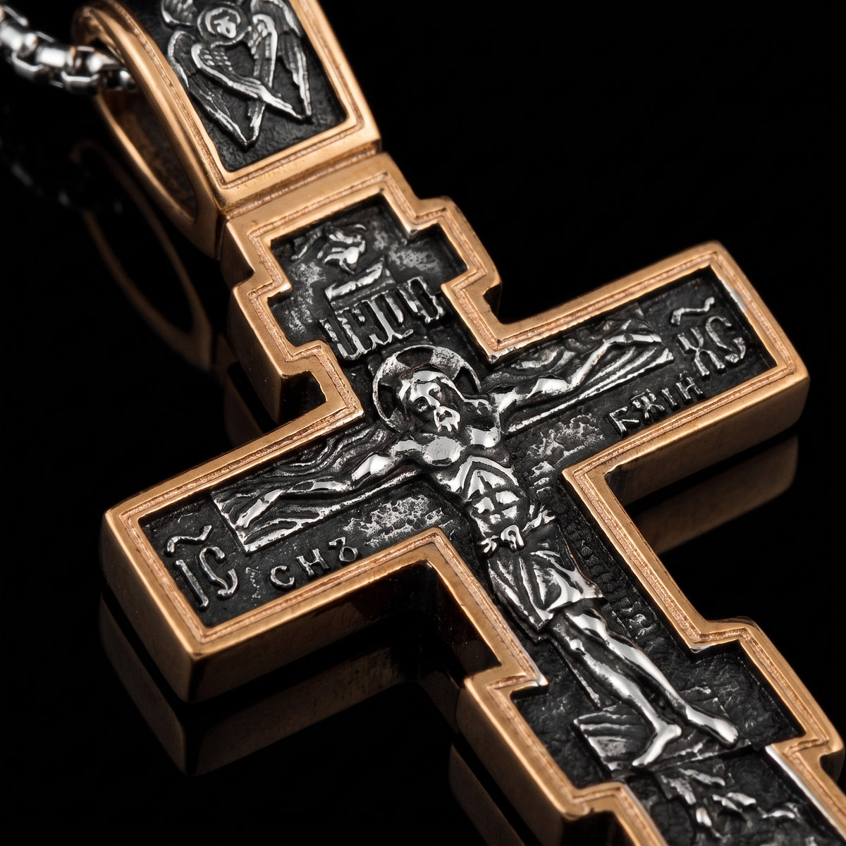 Macro close-up of the Dark Jesus Cross Gold pendant in 316L stainless steel, Outlaws Amsterdam