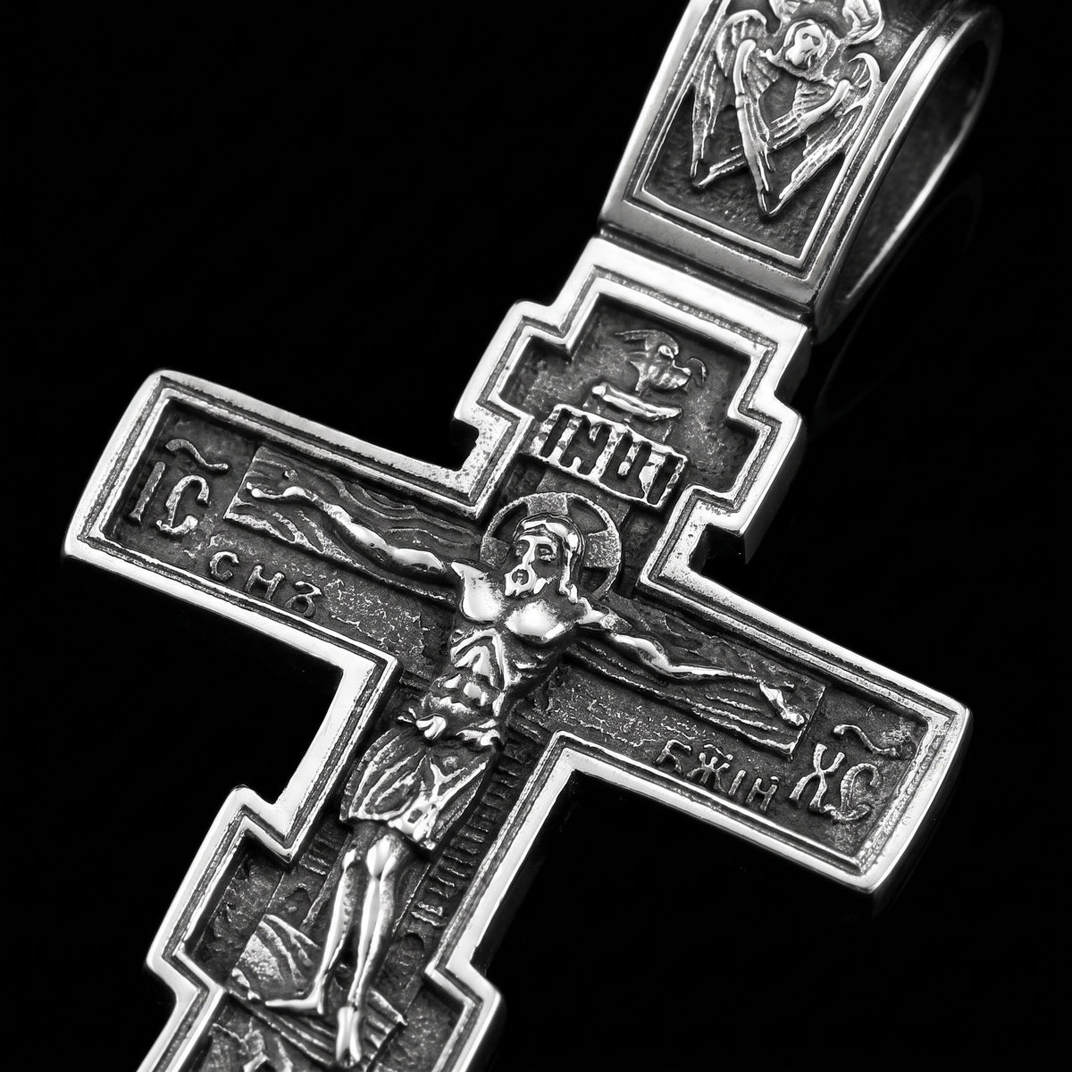 Macro close-up of the Dark Jesus Cross pendant in 316L stainless steel, Outlaws Amsterdam