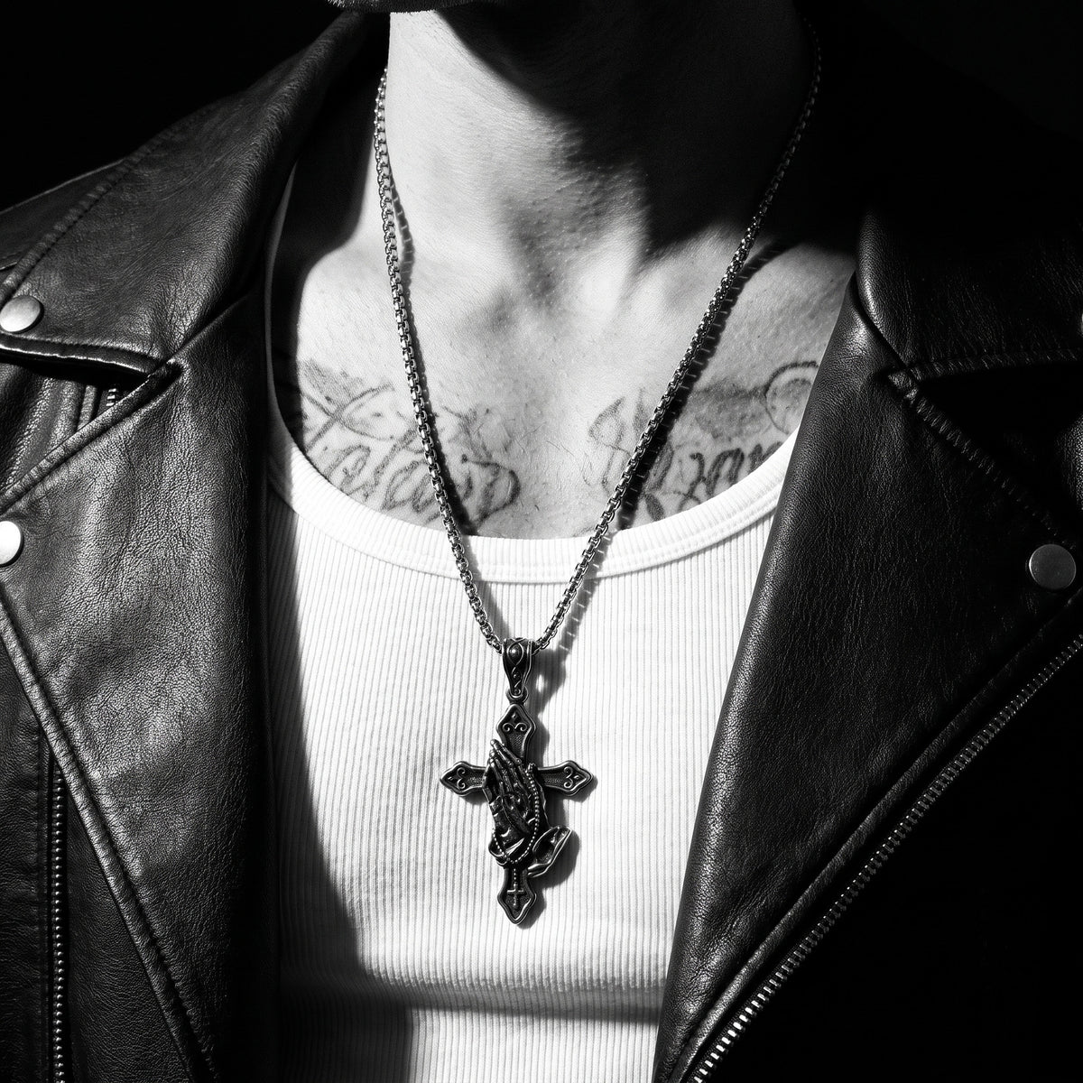 Man wearing the Prayer Cross pendant on a chain, worn on the chest, 316L stainless steel, Outlaws Amsterdam