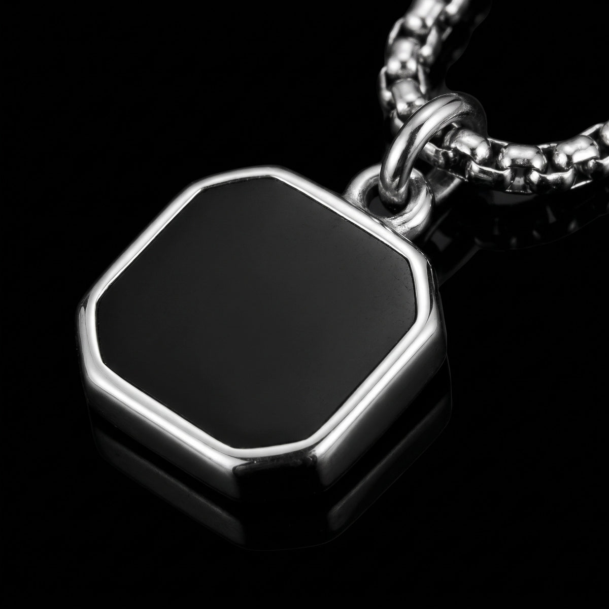 Macro close-up of the The Onyx Badge pendant in 316L stainless steel, Outlaws Amsterdam