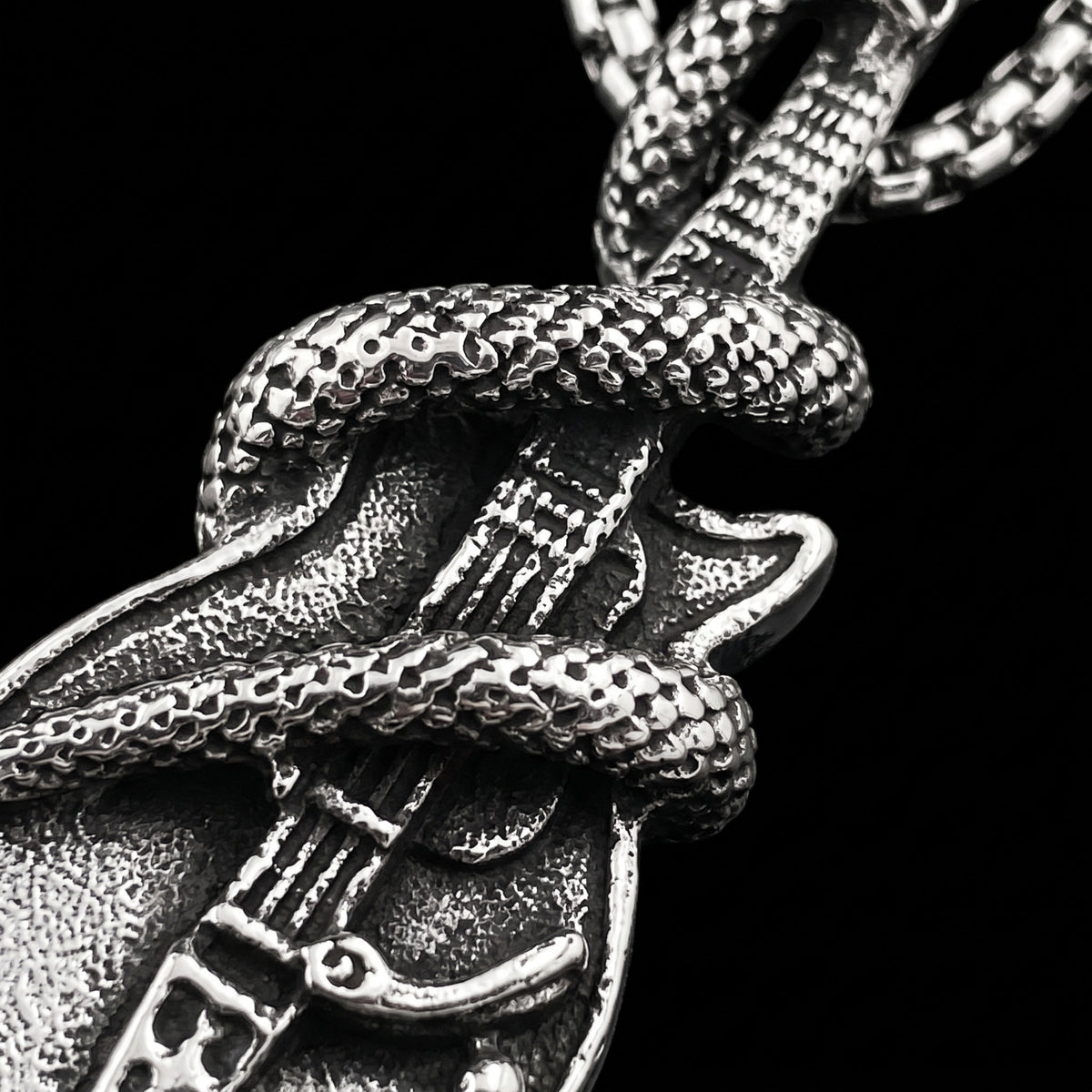 Macro close-up of the The Serpent Guitar pendant in 316L stainless steel, Outlaws Amsterdam