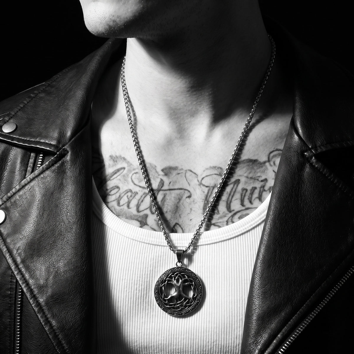 Man wearing the Tree Of Life pendant on a chain, worn on the chest, 316L stainless steel, Outlaws Amsterdam